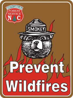 Road sign: North Carolina Division of Forest Resources, Smokey Bear, and Prevent Wildfires.