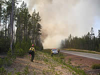 Smoke rising over Highway 138 as Engine 9151 crew patrols the roadside