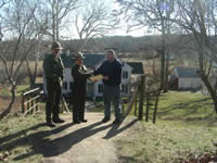 Picture of Assistant Forest Fire Warden John Trimble receives RFA funding from Park Ranger Steve Ambrose and Superintendent Edie Shean-Hammond.