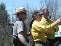 Picture of Jim Barnes and Missy and Norm Forder listening at the Beahms Gap Prescribed Fire briefing.
