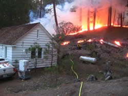 Jack Fire burning near a house.