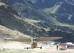 A small plane lifting off the runway from Big Bar Airstrip.