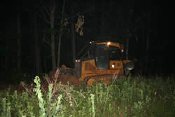 Virginia Department of Forestry tractor and plow operating at night.
