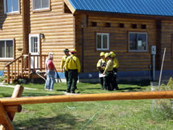Firefighters talk with homeowners about their wildfire risk assessment during All Fire Day.