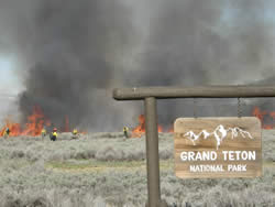 Firefighters setting fire to the sagebrush near the Granite Entrance Station of Grand Teton National Park.