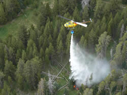 A helicopter crops water on a hotspot on the LeHardy Fire.