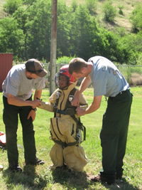 A students dressed up in smokejumper protective equipment.