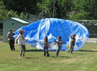 Students playing with a parachute.