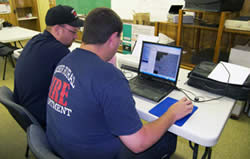 Weiser Rural Fire Department crew members entering assessment information into a computer.