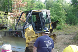 An operator prepares to demonstrate a tractor plow.