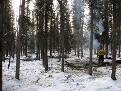 Crewman burning piles.