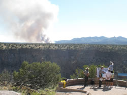 Park rangers discussing the San Miguel Fire with visitors at the scenic overlook on the Monument's entrance road.