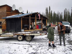 An official from the Alaska Department of Natural Resources discusses Firewise improvements with a homeowner.