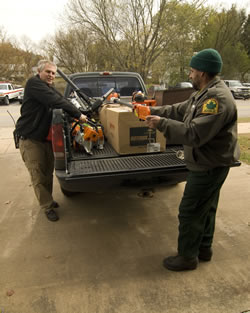 Mike Peck, New River Gorge, and Tom Halki, West Virginia Division of Forestry, finish loading the equipment.