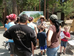 Ranger talking with visitors.