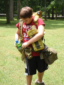 Joshua Doyle tries on a fire pack during Fire Field Day.