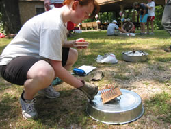 Project GLADE student lighting a matchstick forest.