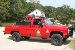 Brush truck with fire fighting equipment.