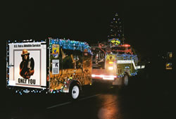 Fire prevention education trailer during a winter light parade, all lit up.
