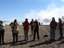 Members of the public listen as they watch and are briefed on prescribed fire operations at Bosque del Apache National Wildlife Refuge.