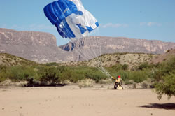 Smokejumper pulling a parachute in.