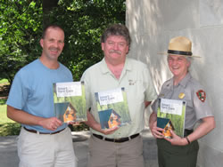 Dave Close, Frank Reilly, and Barb Stewart holding copies of the Smart Yard Care handbook.