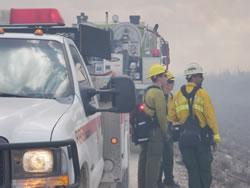 Everglades firefighters Colleen Holland and Erika Hoopes consult with Florida Forest Service division supervisor Gary Lewis..