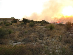 The fire approaching structures.