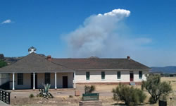 View of the Rock House Fire from the Headquarters Building at Fort Davis National Historic Site.