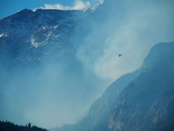 A type one helitanker flies toward Forest Canyon.