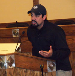 Initial attack incident commander Paul Cerda answers questions at a packed community meeting.